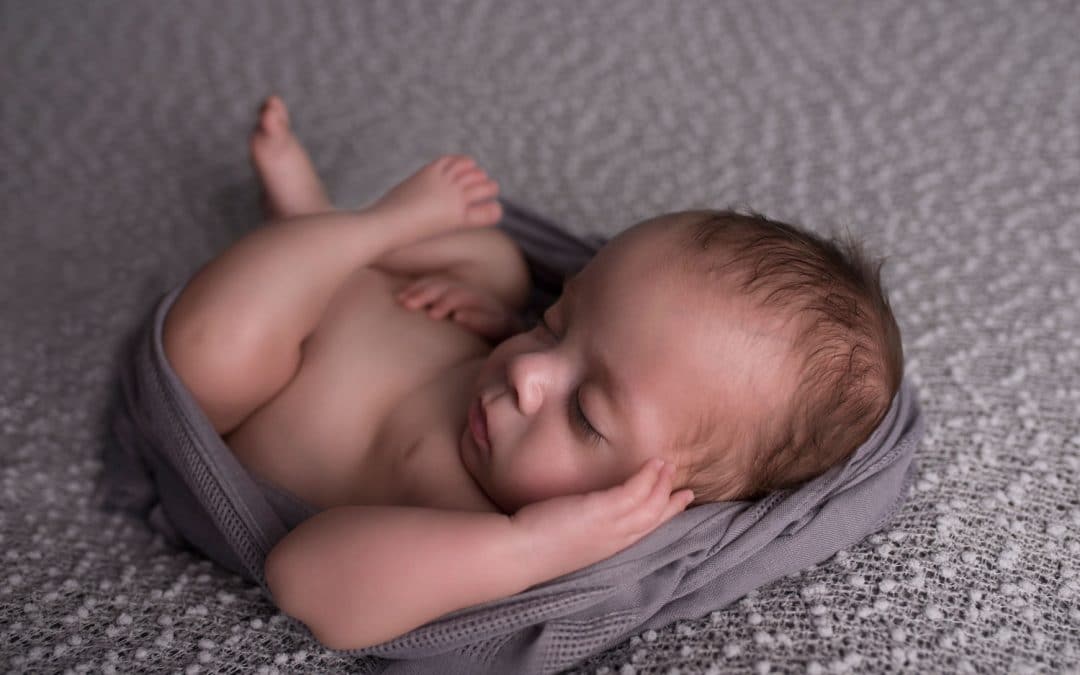 newborn baby in huck finn pose