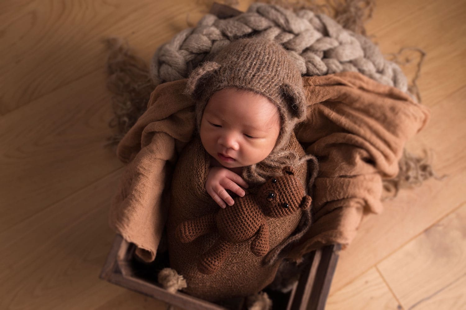 newborn baby in wooden crate
