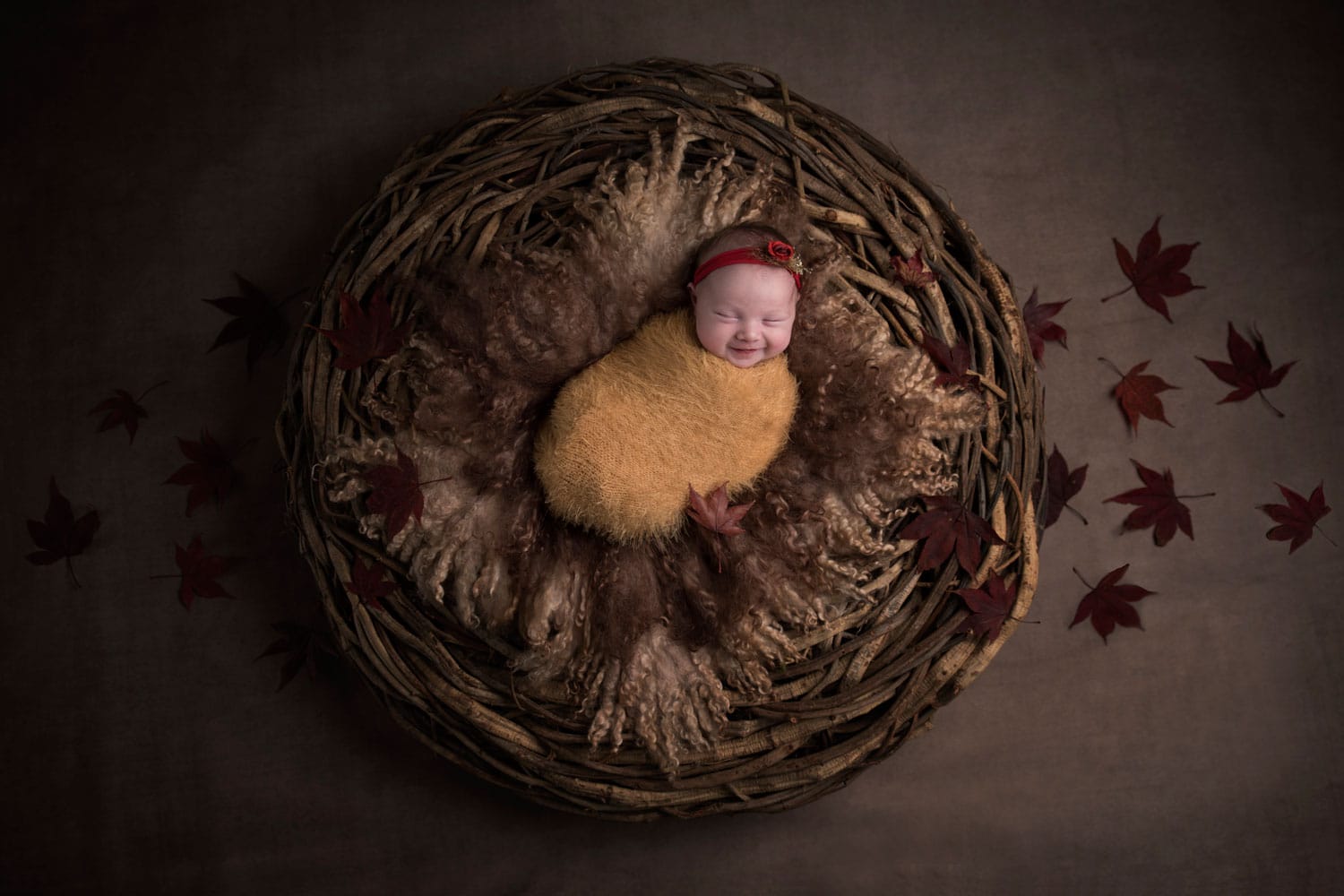newborn baby in brown basket by Newborn Photographer Cheshire