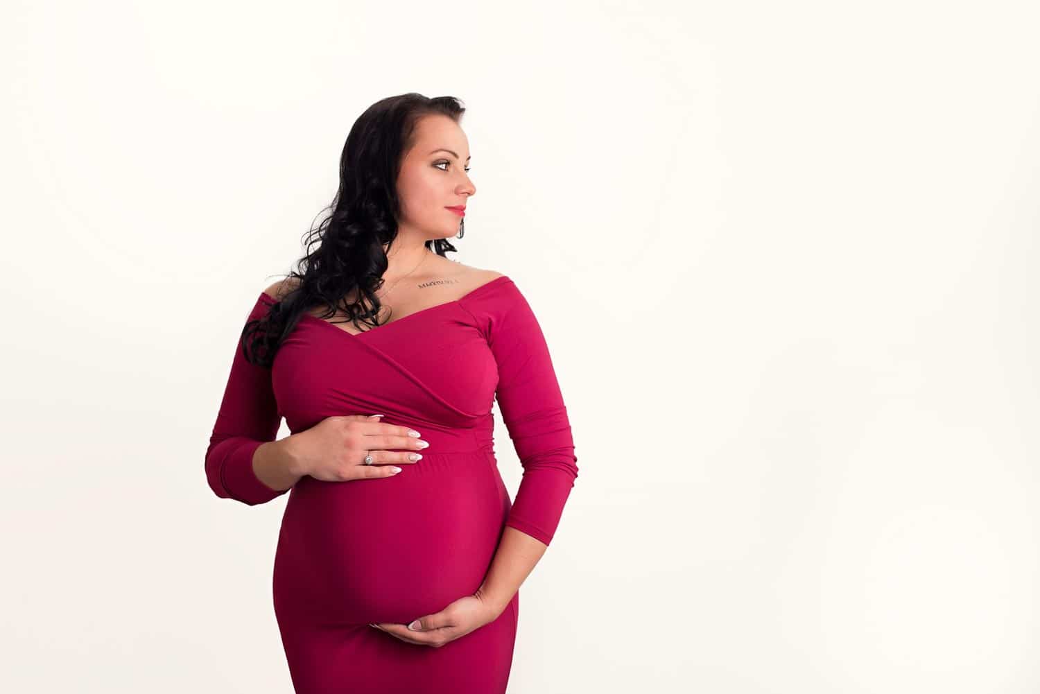 professional pregnancy portrait in red maternity dress photographed by Maternity Photographer Manchester