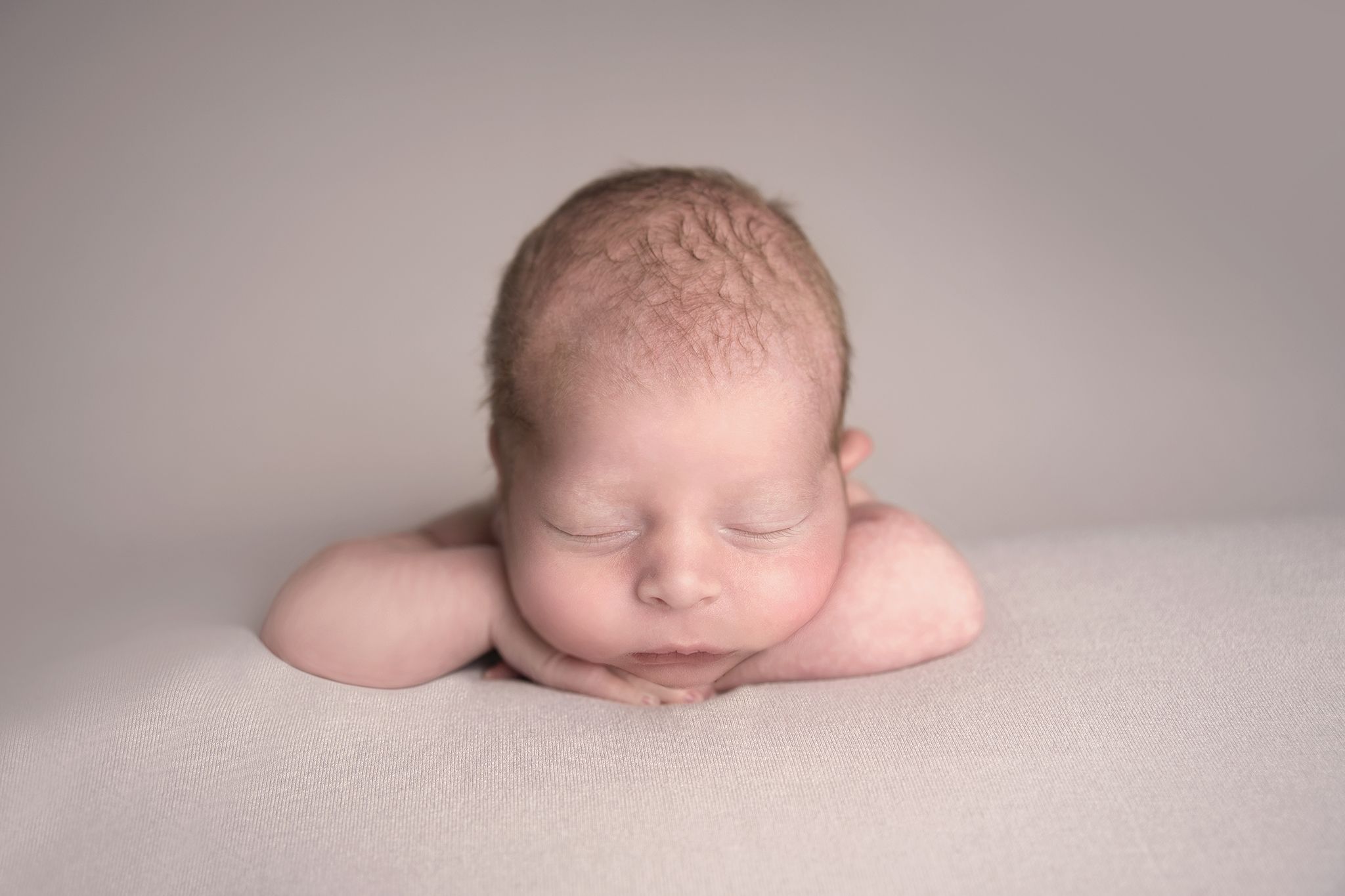 newborn boy chin up photographed by Newborn Photographer Cheshire