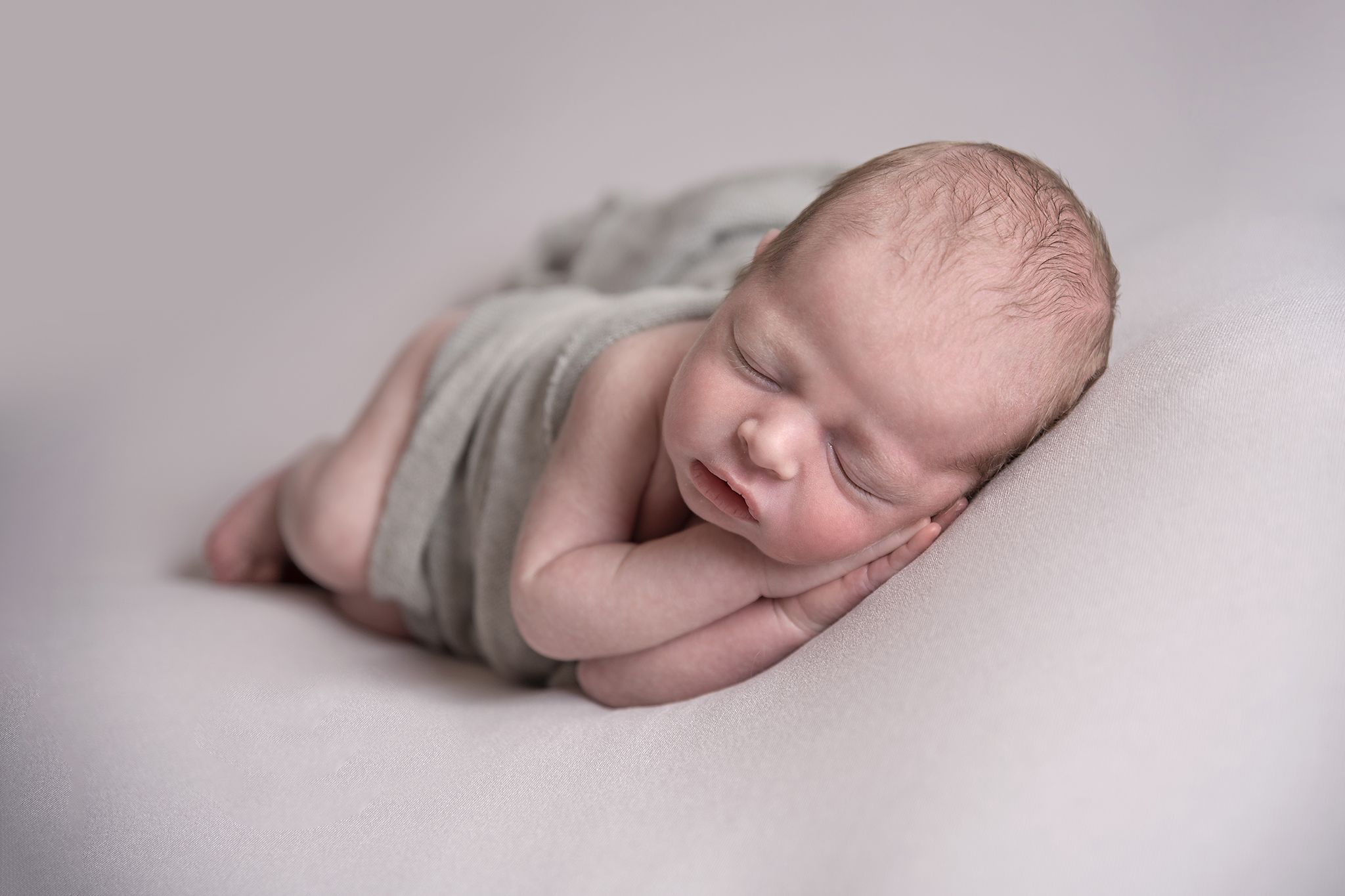newborn boy side pose photographed by Newborn Photographer Cheshire