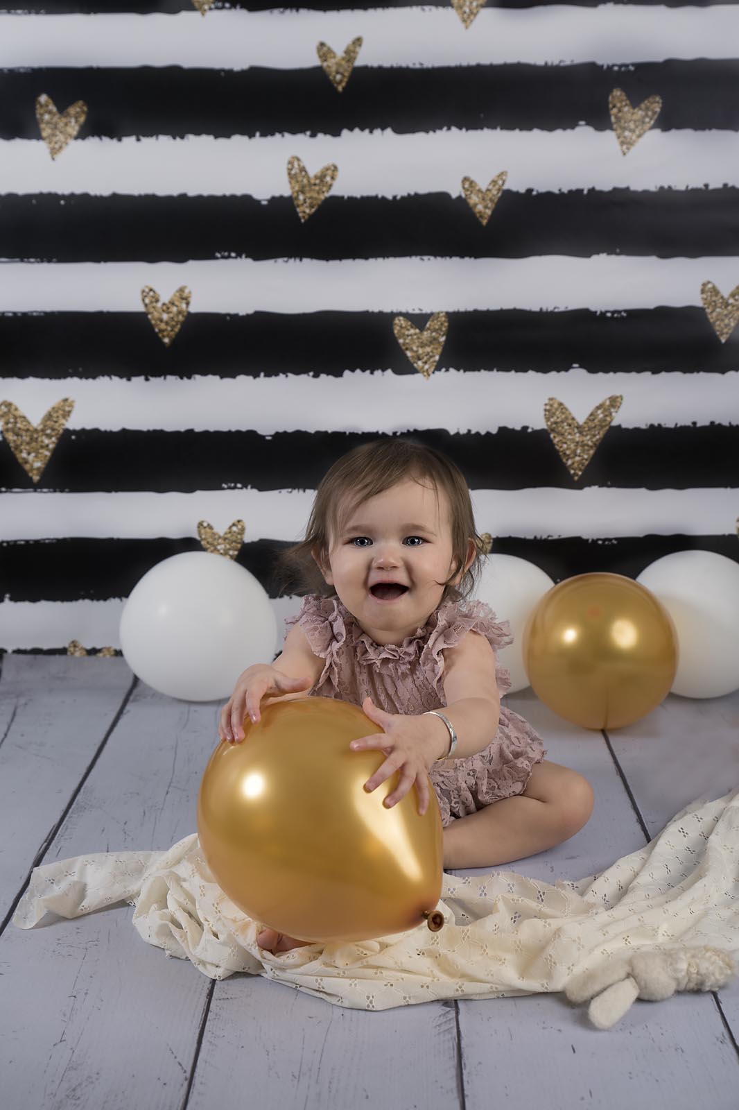 baby girl playing with baloons photographed by Baby Photographer Manchester