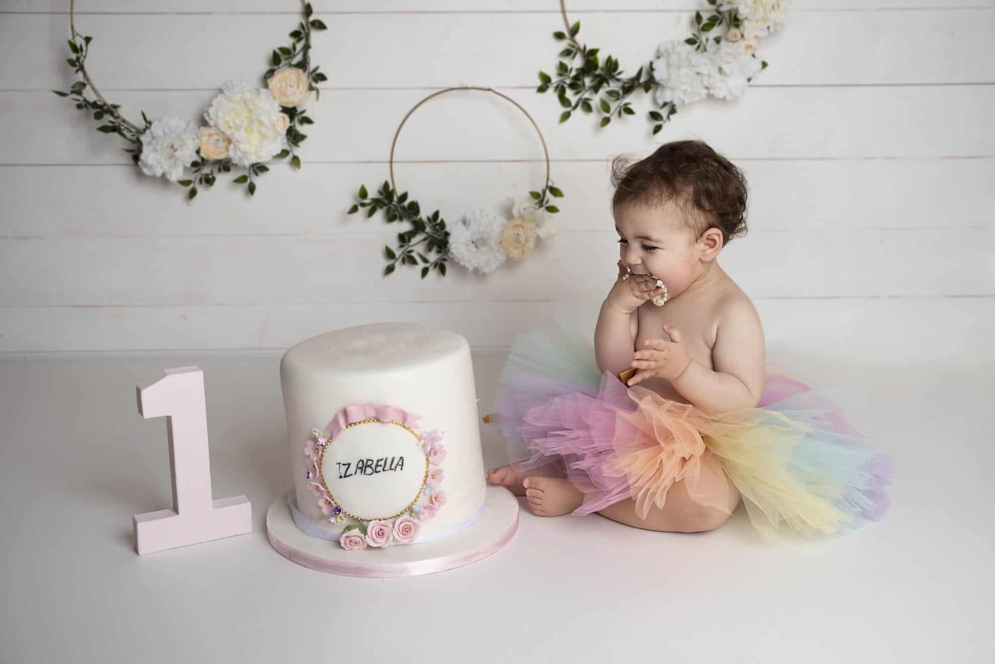 little girl eating a cake photographed by cake smash photography Manchester