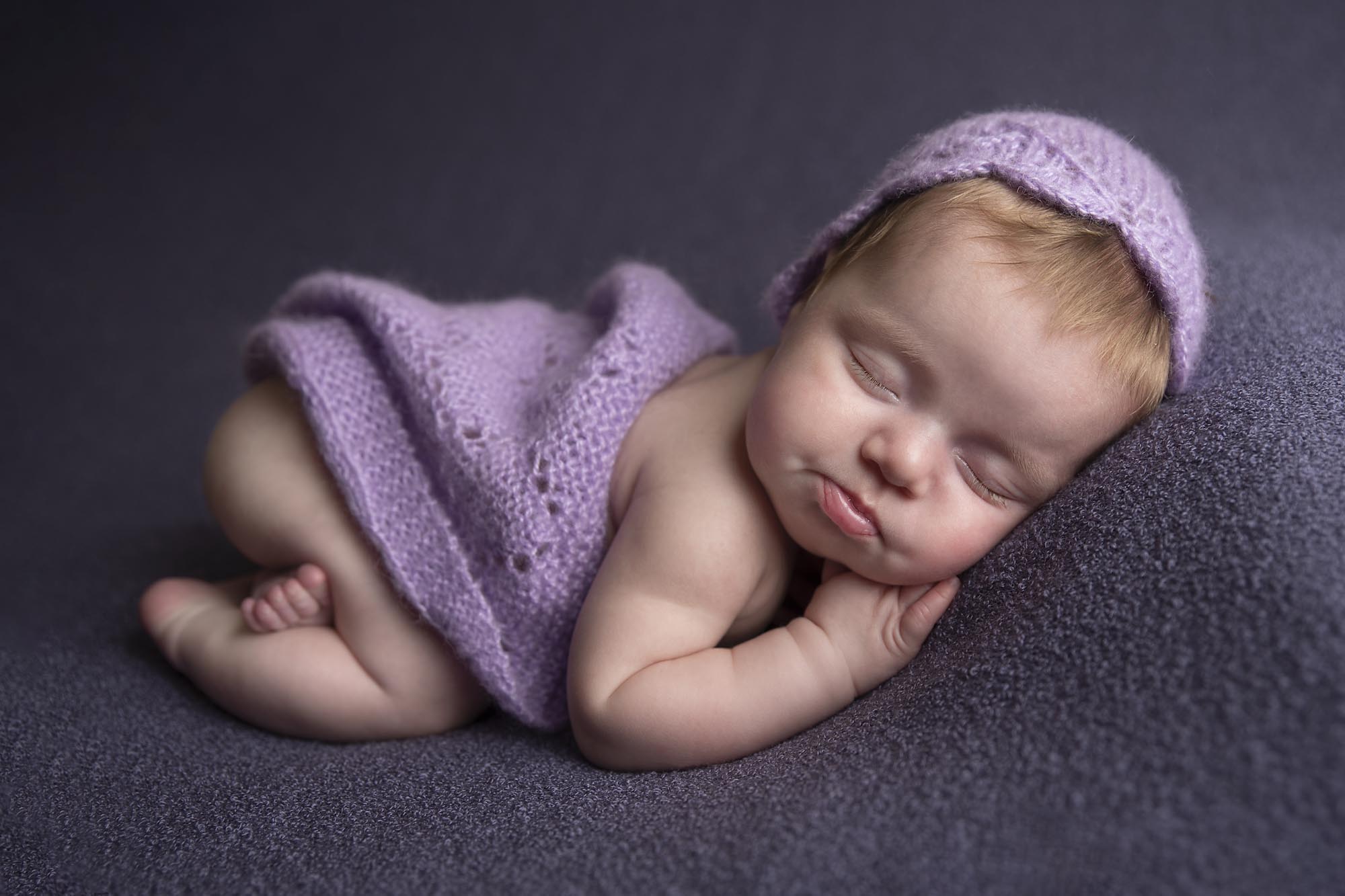 newborn baby girl is sleeping on the pilow taken by newborn photography manchester