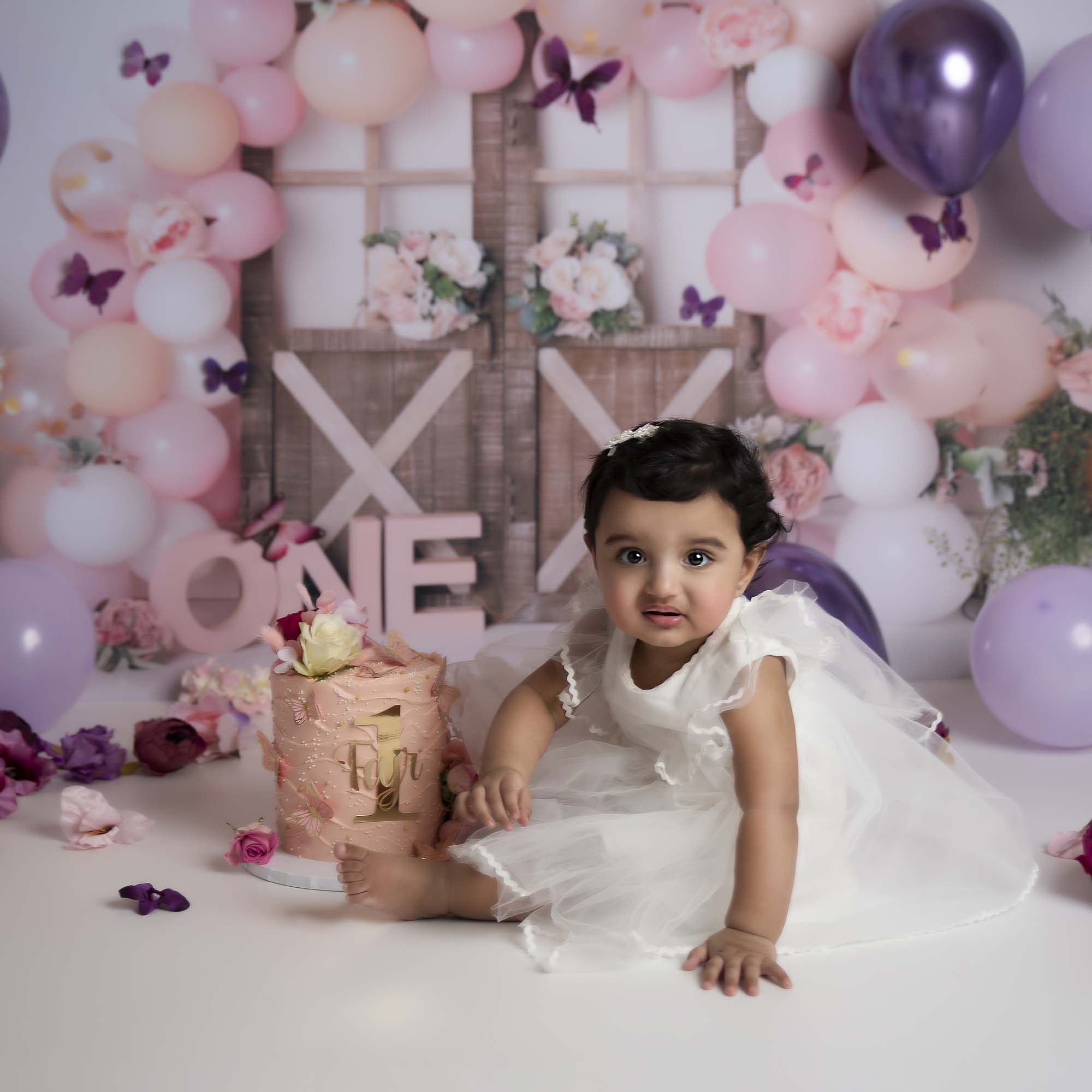 cakesmash photoshoot with one year old little girl and cake photographed by cake smash photography Manchester