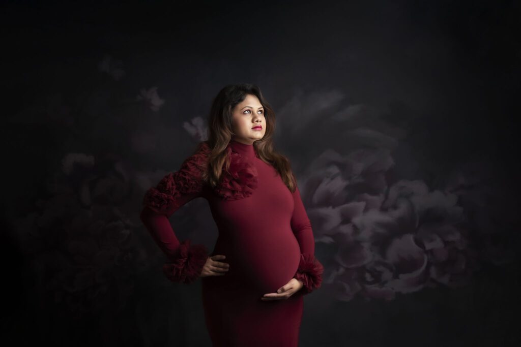 maternity photography studion in red dress and flowery background