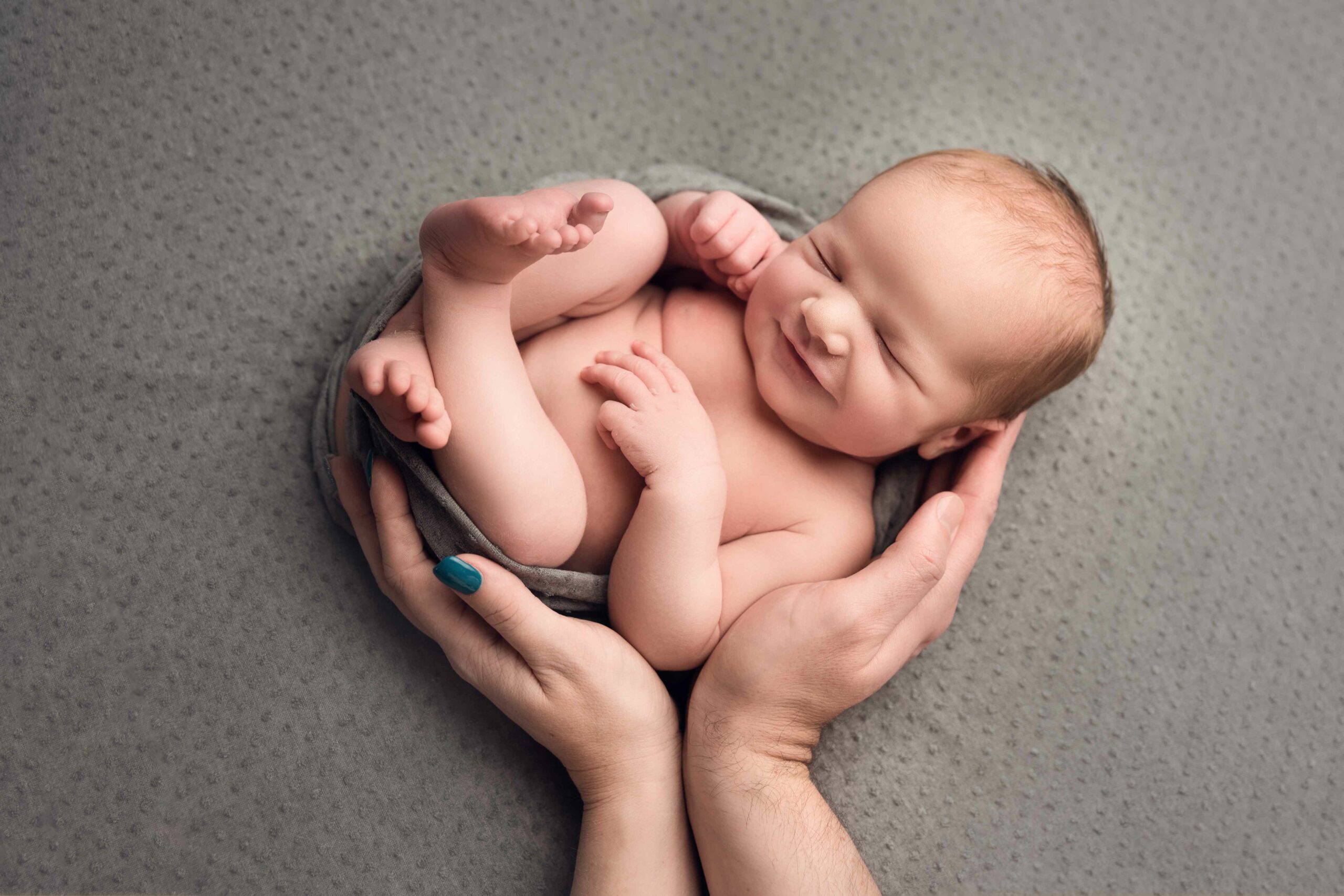 newborn family photo shoot baby is smiling taken by Dora Horvath